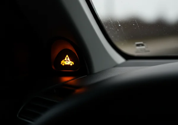 Car dashboard with warning light, symbolizing mild depression.